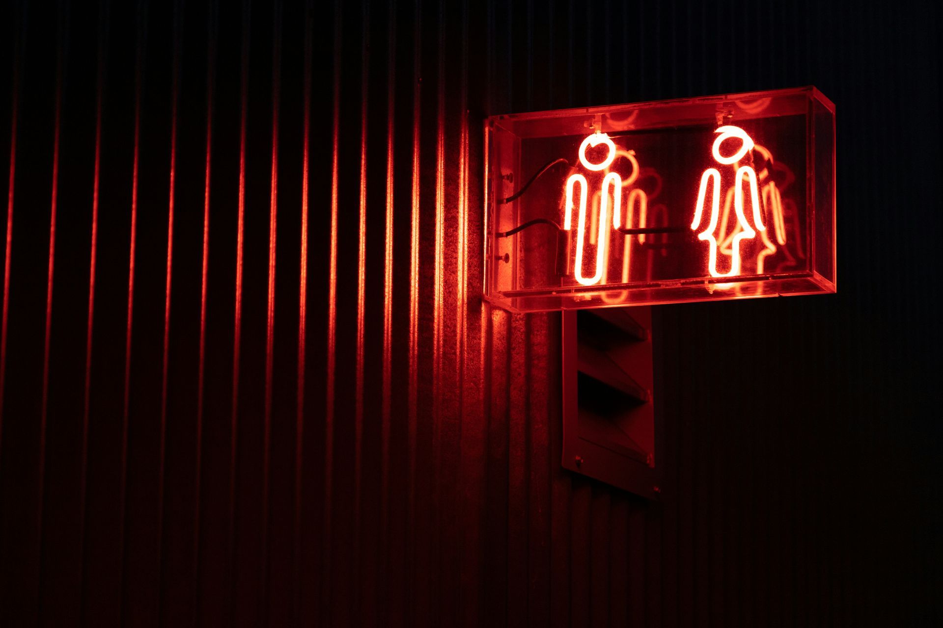 A group of people are putting their hands together in a circle.