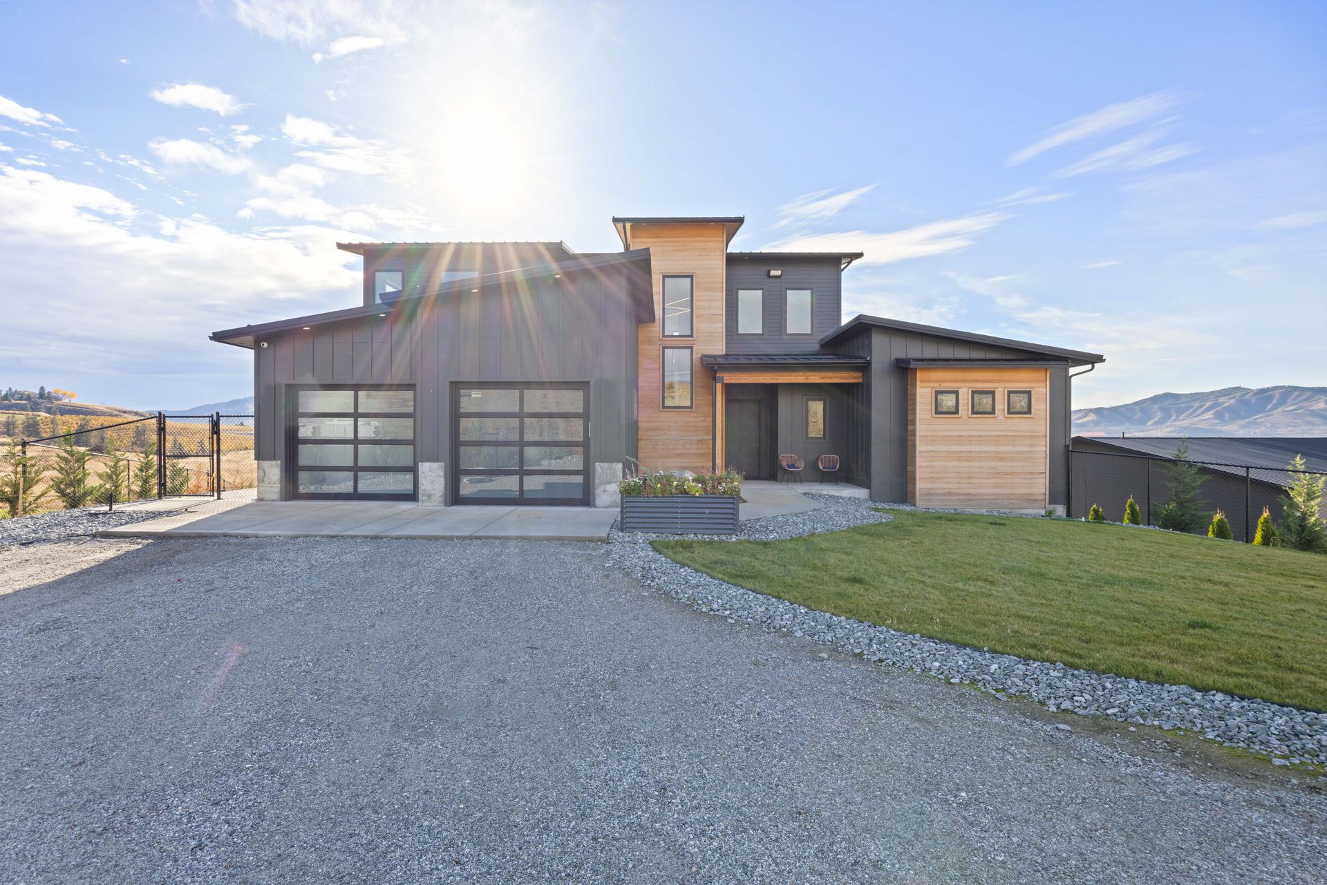 A child's bedroom with a white desk, bunk beds, and a wooden door. The room has beige carpeting and cream-colored walls.