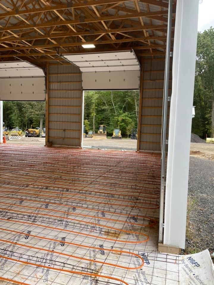 The inside of a building under construction with a concrete floor.