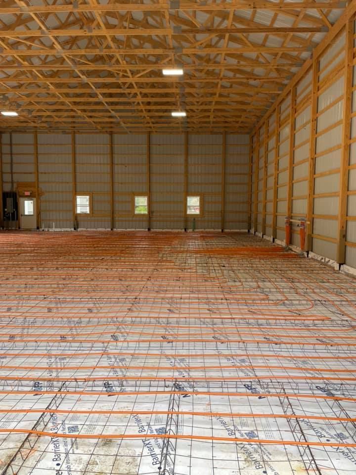 A large warehouse with a concrete floor under construction