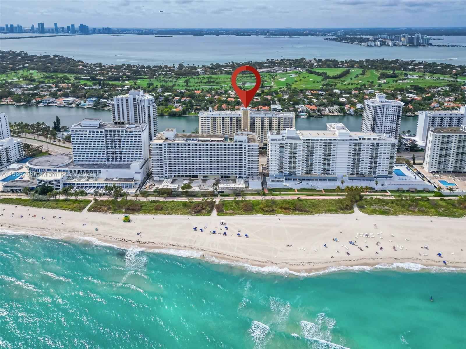 A patio with a lot of furniture and lights at night.