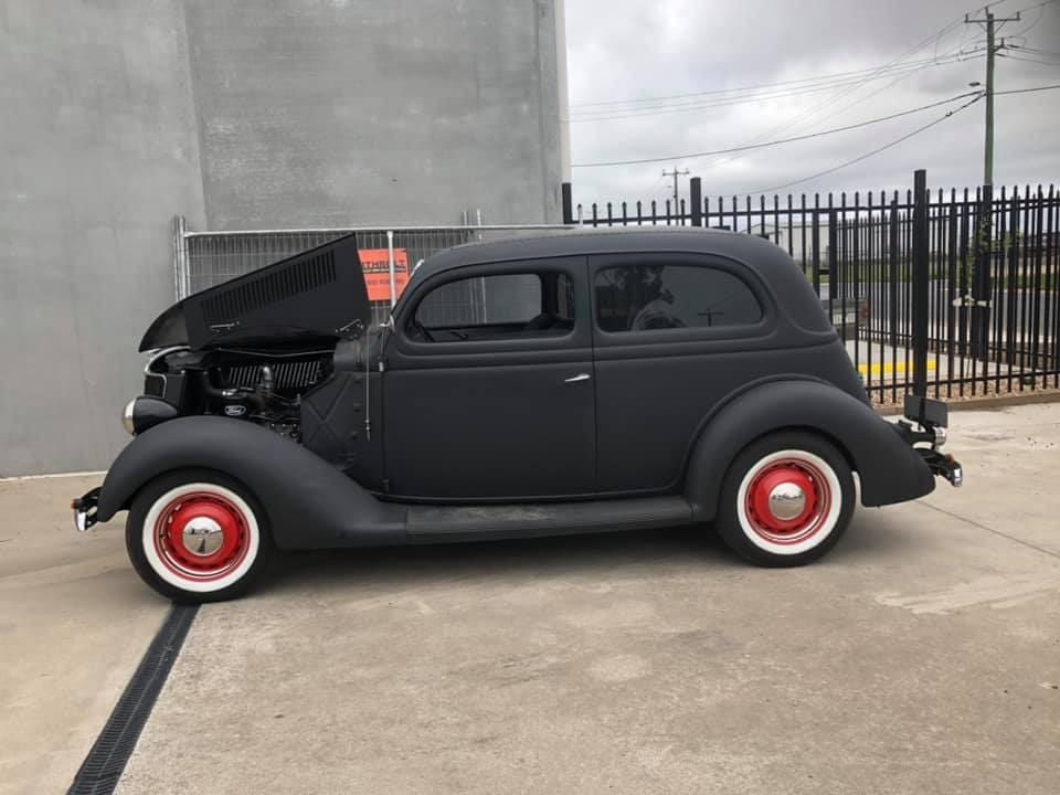 A Black Car With the Hood Up is Parked in a Parking Lot — ARB Budget Tyres in Delacombe, VIC