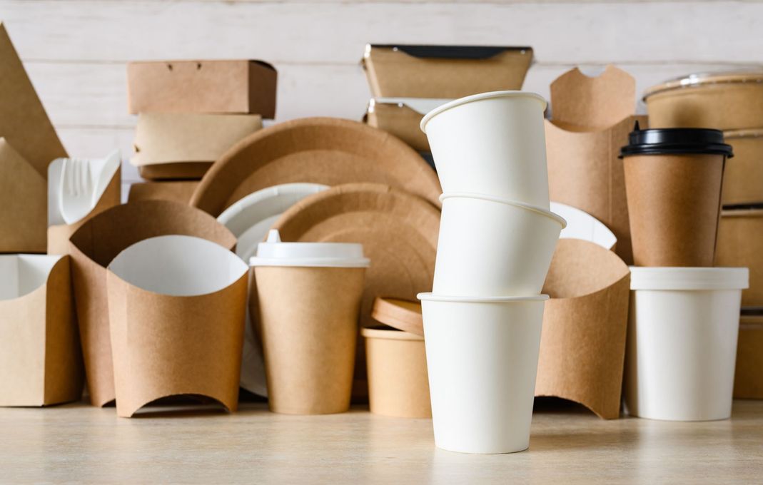 A table topped with a variety of paper containers and cups.