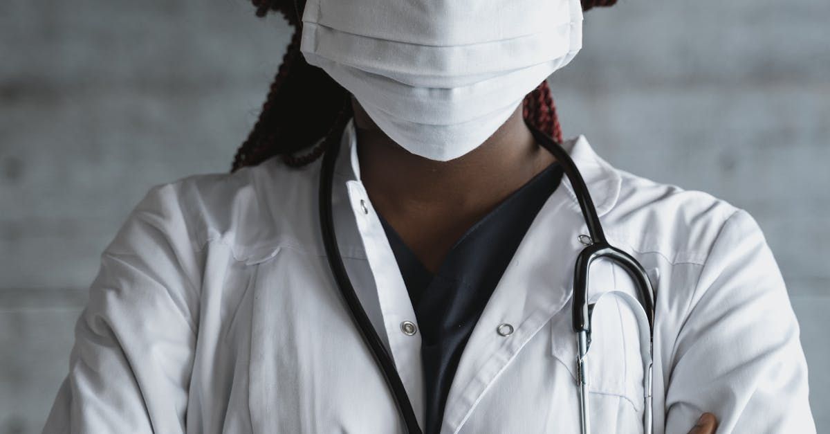 A doctor wearing a mask and a stethoscope around her neck.