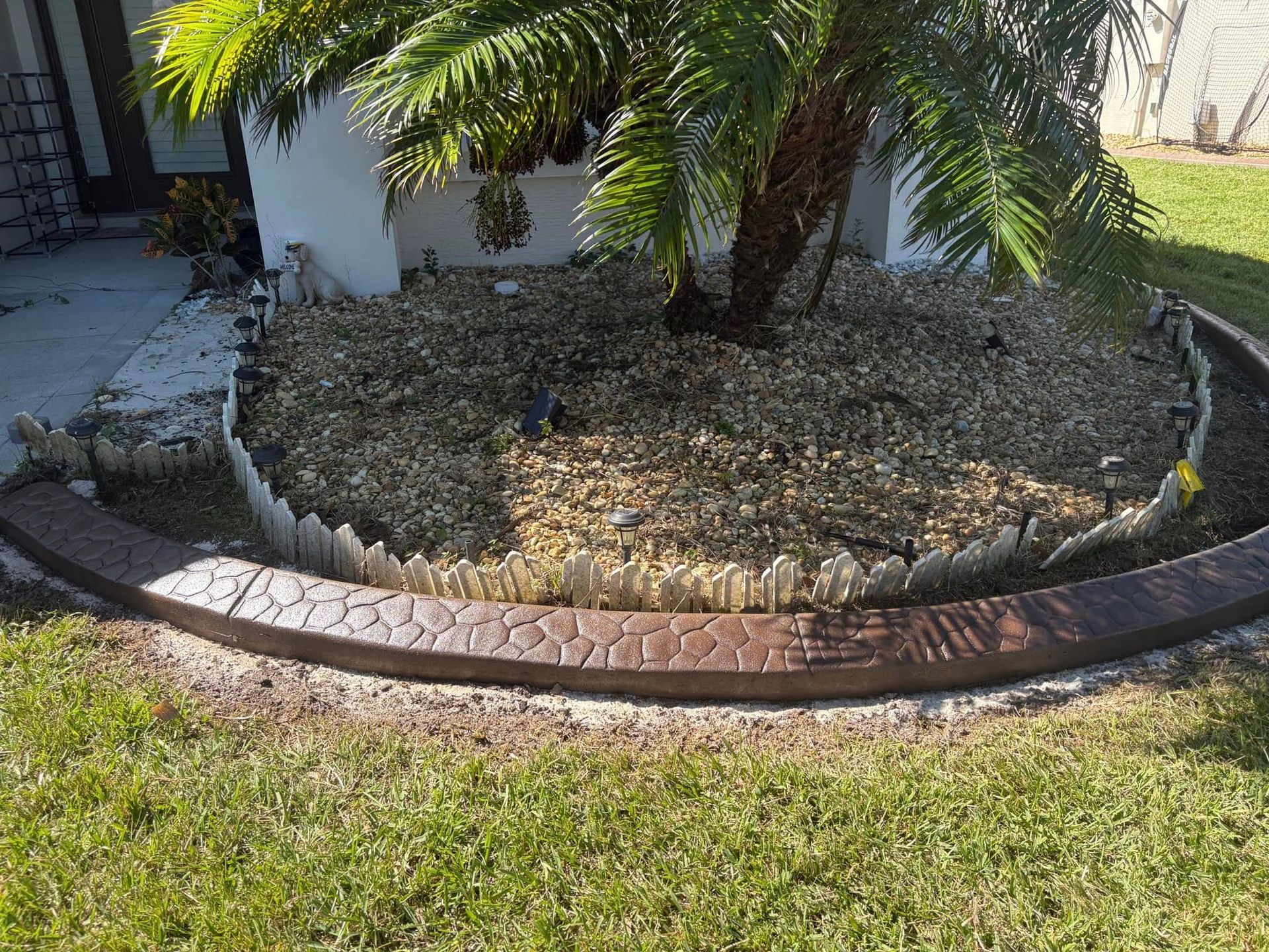 There is a palm tree in the middle of the yard.