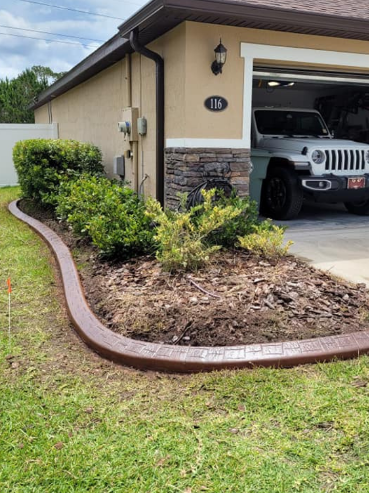 A jeep is parked in front of a house with a curb.
