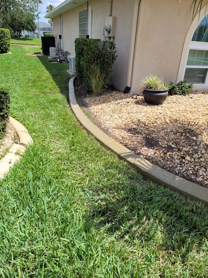 A house with a lush green lawn and a potted plant in front of it.