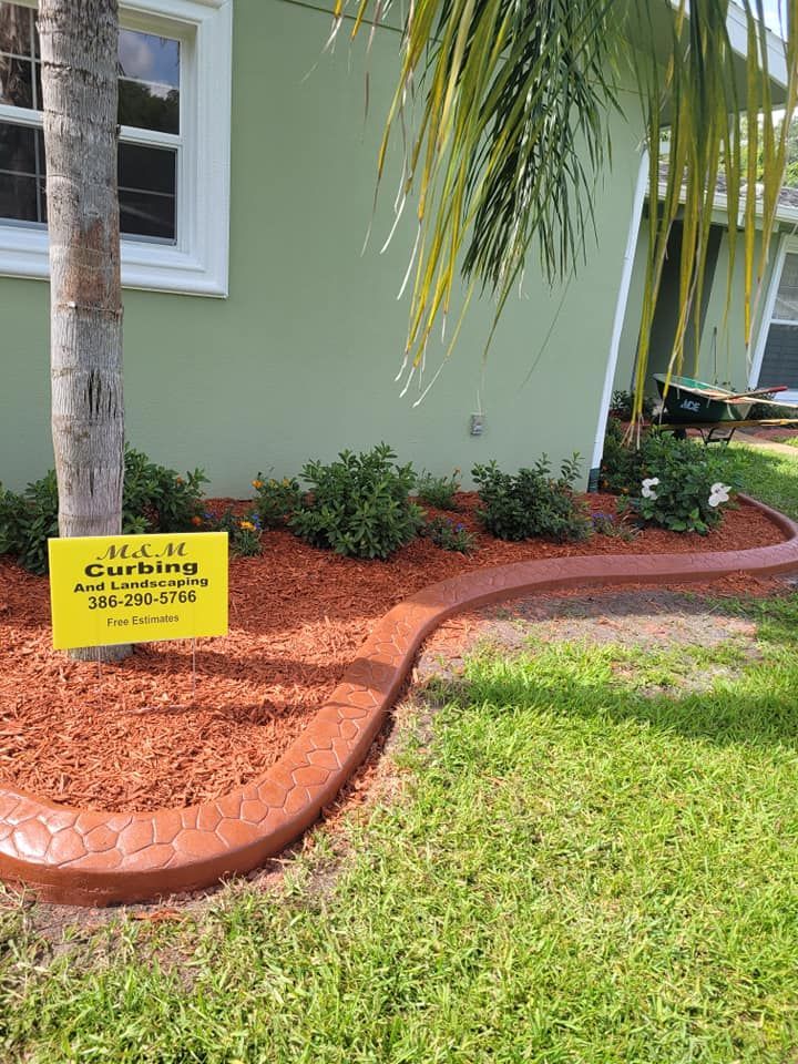 A house with a curb and a sign in front of it.