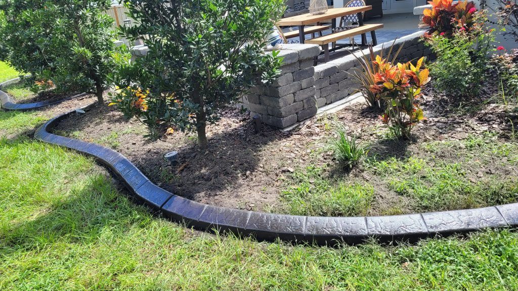 There is a concrete curb in the middle of the yard.