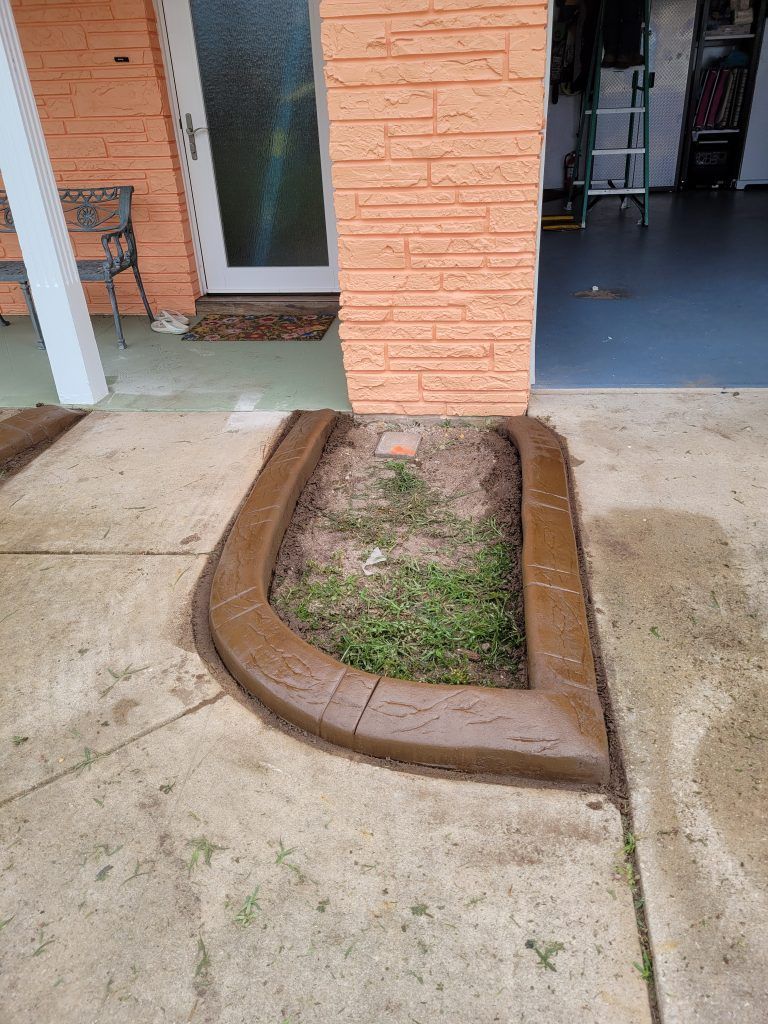 A brick building with a concrete curb in front of it.