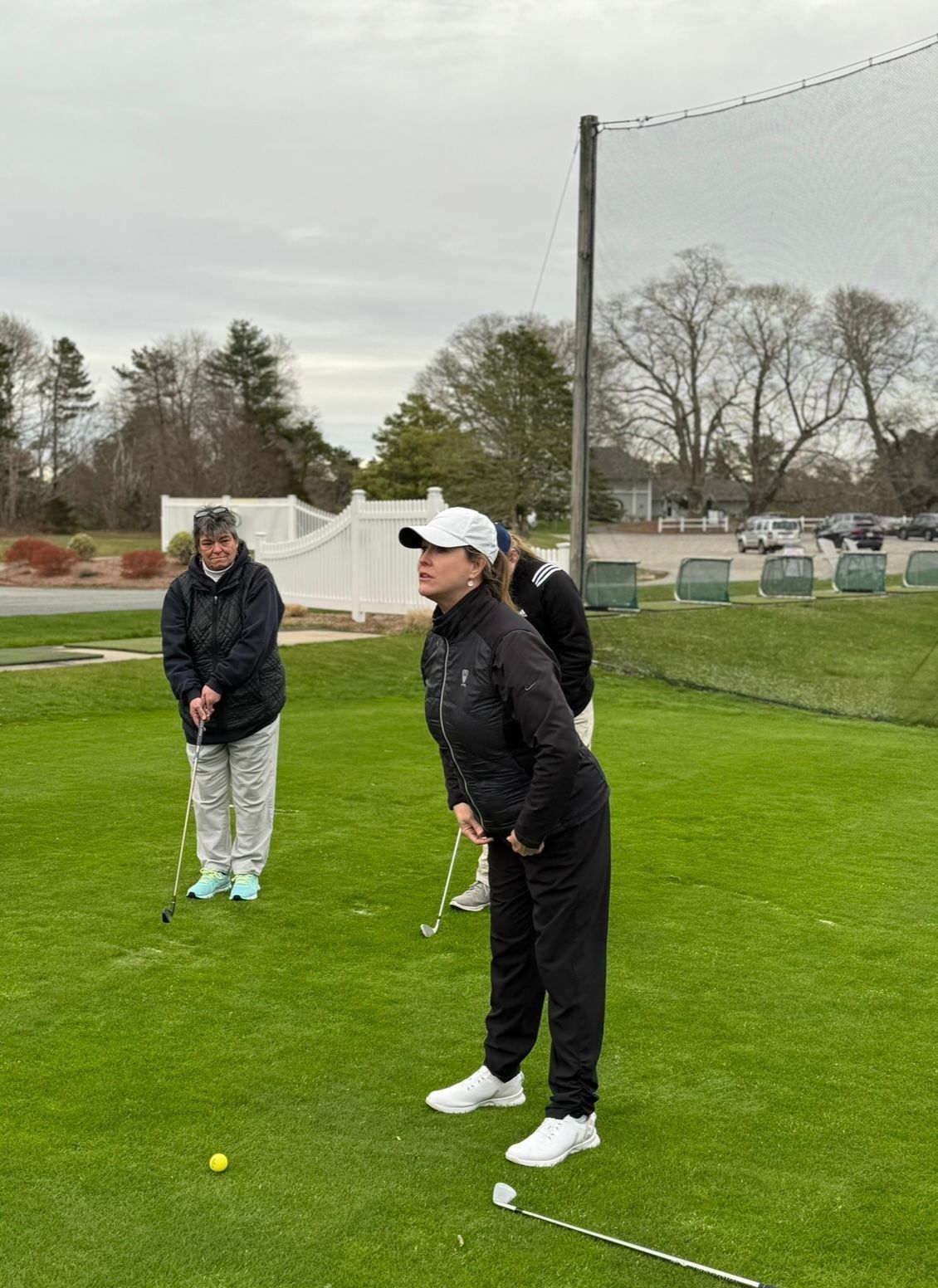 A group of people are playing golf on a golf course.