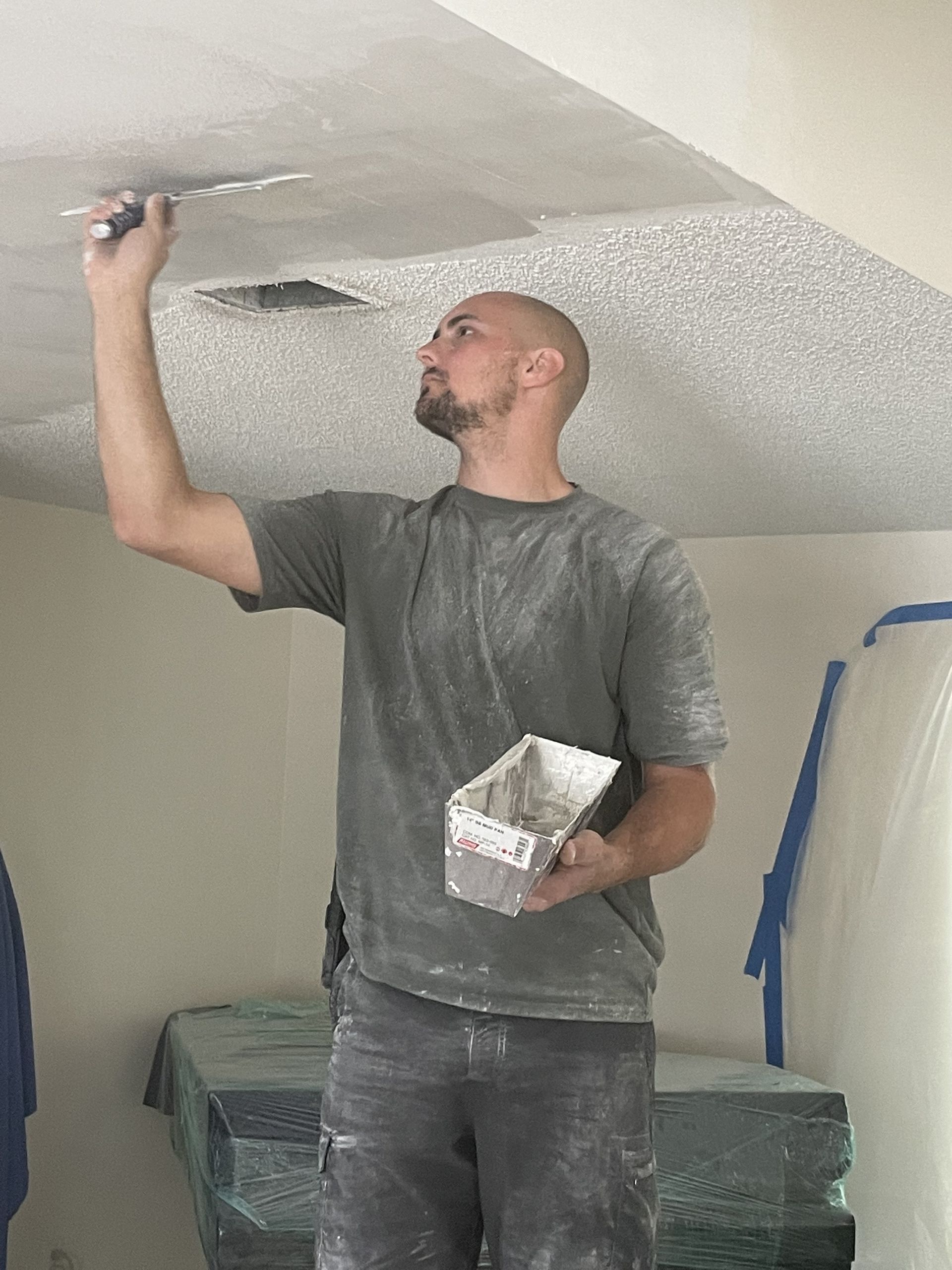 man painting a room ceiling