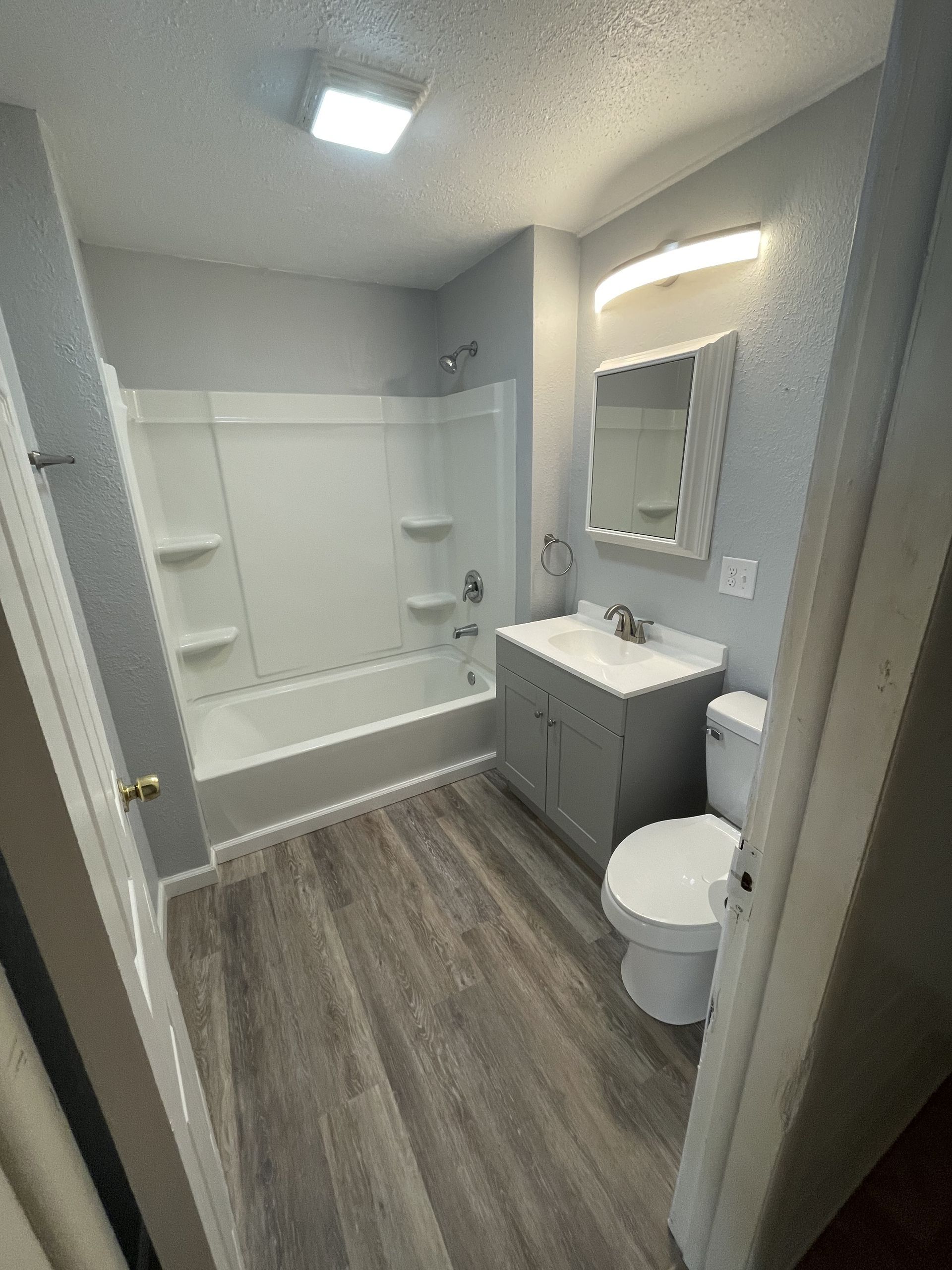 newly renovated bathroom with white and gray paint