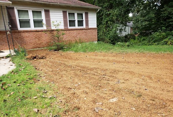 A house with a lot of dirt in front of it.