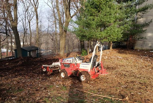 A red and white lawn mower is parked in a yard.