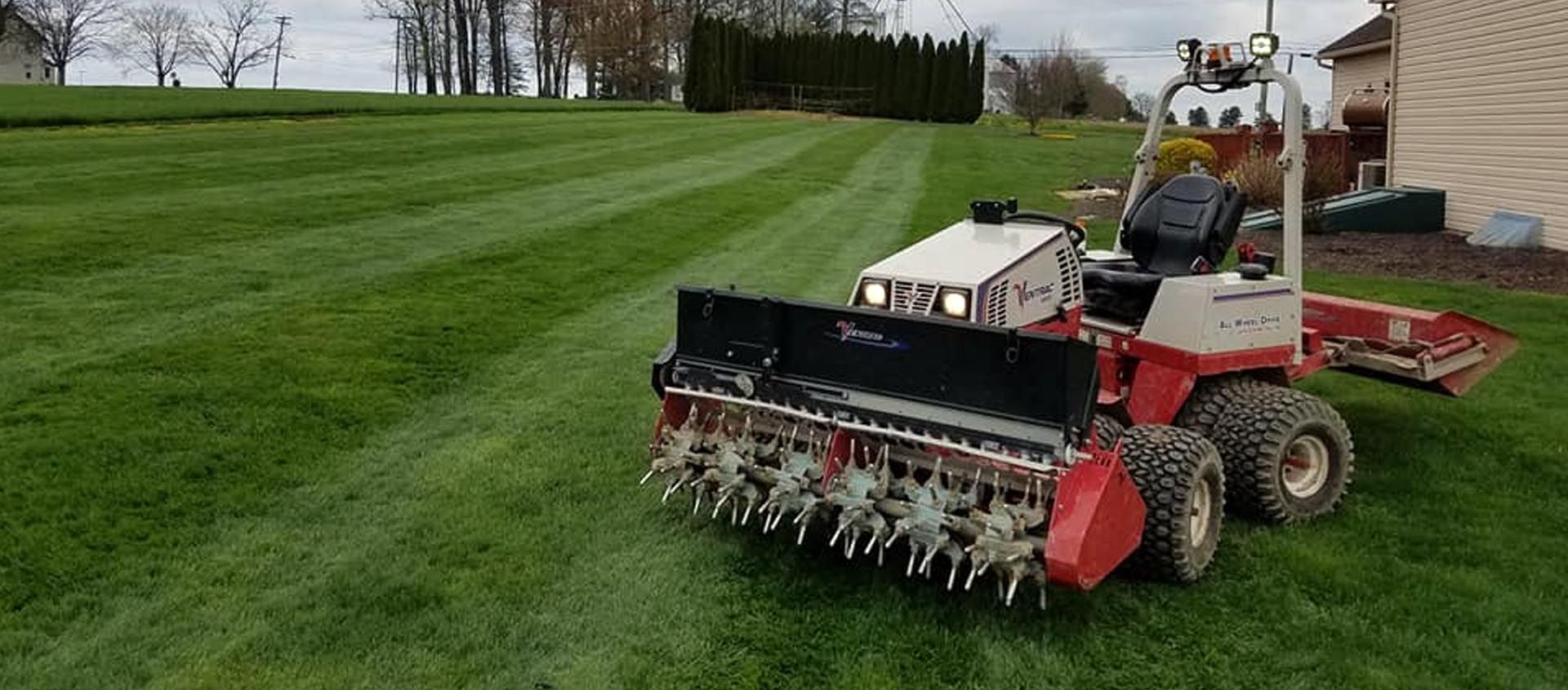 A lawn mower is sitting on top of a lush green lawn.