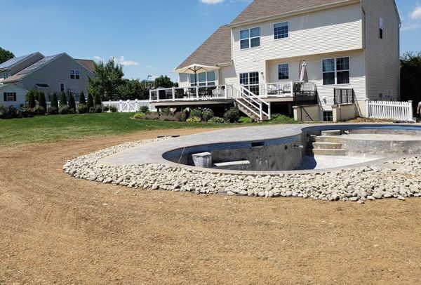 A large white house with a swimming pool in front of it