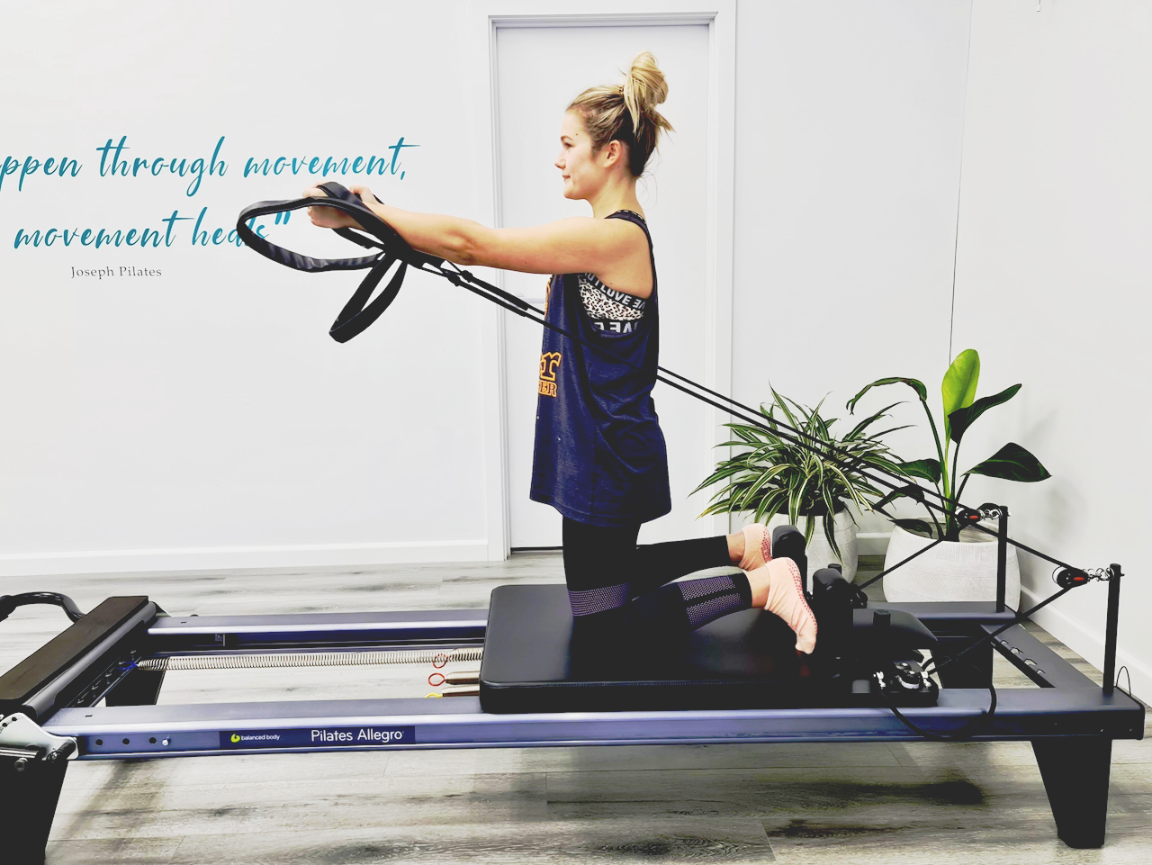 Woman exercising on a Pilates Reformer machine