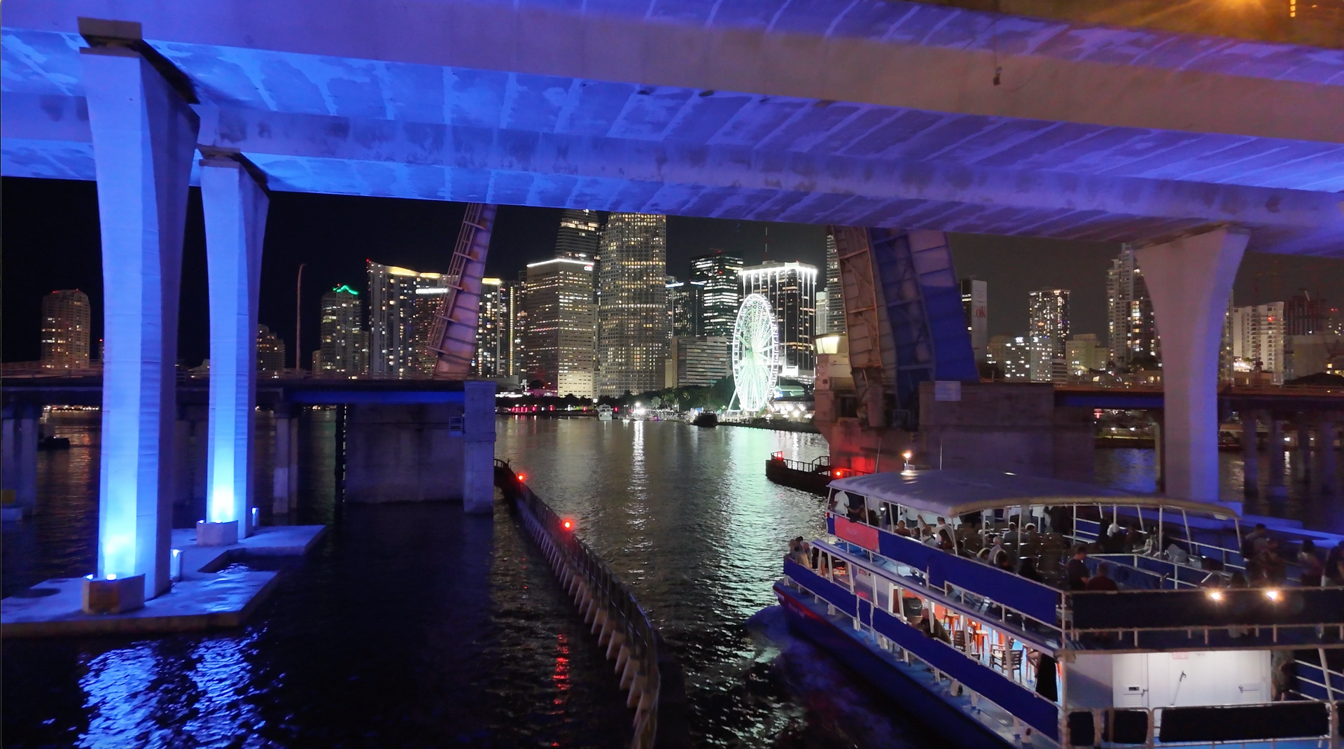 Miami night Cruises returning to Bayside Marketplace passing under the Port of Miami Bridge.