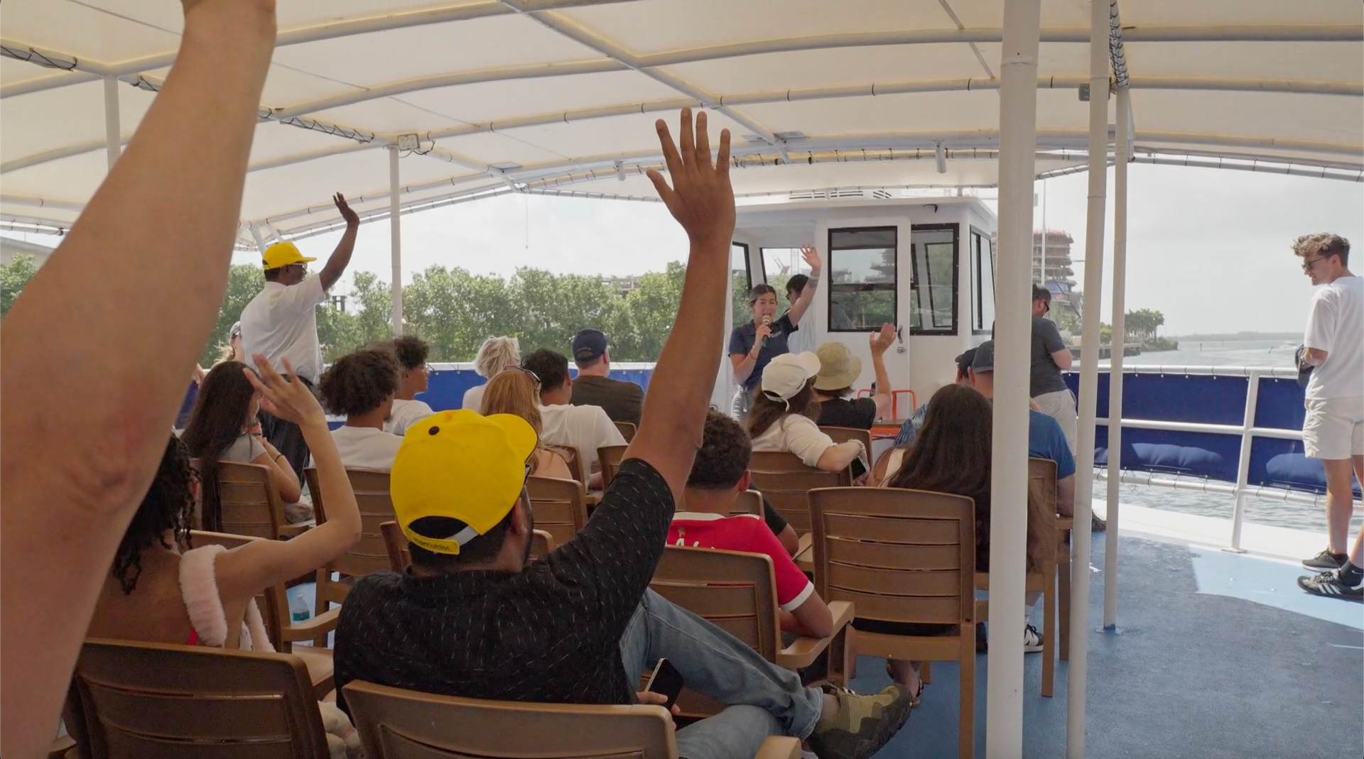 Miami boat Tour passengers interacting with the tour guide on the top deck of the Miami Star island Cruise