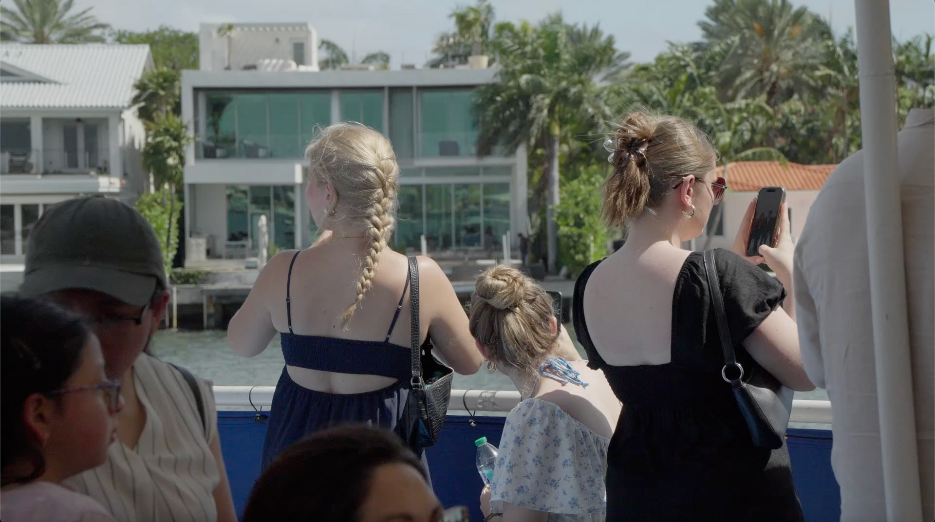 Passengers taking photos of Star island Miami from the top deck of the Star Island Boat tour