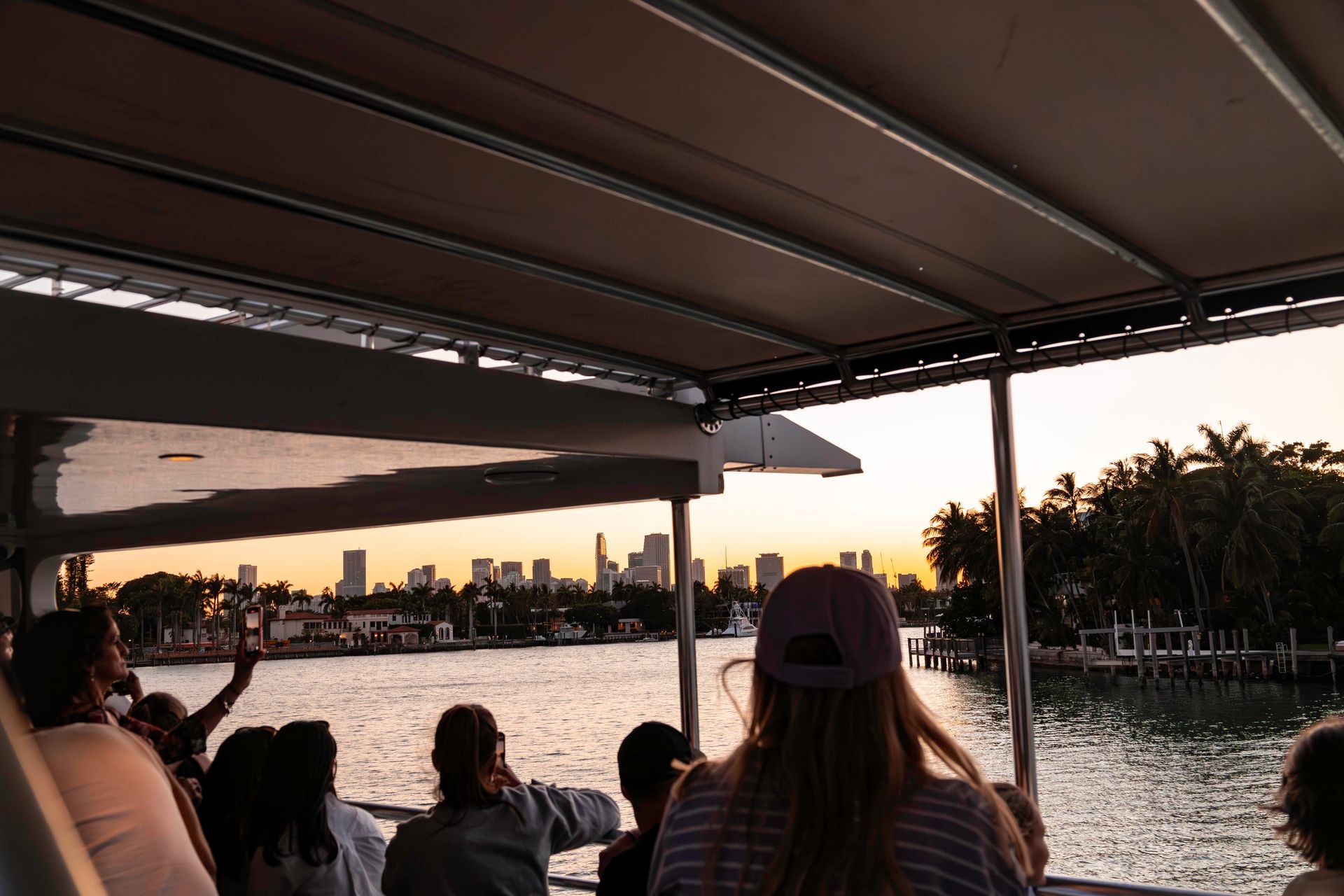 Guest taking pictures of the Star island during the Night Cruise in Miami