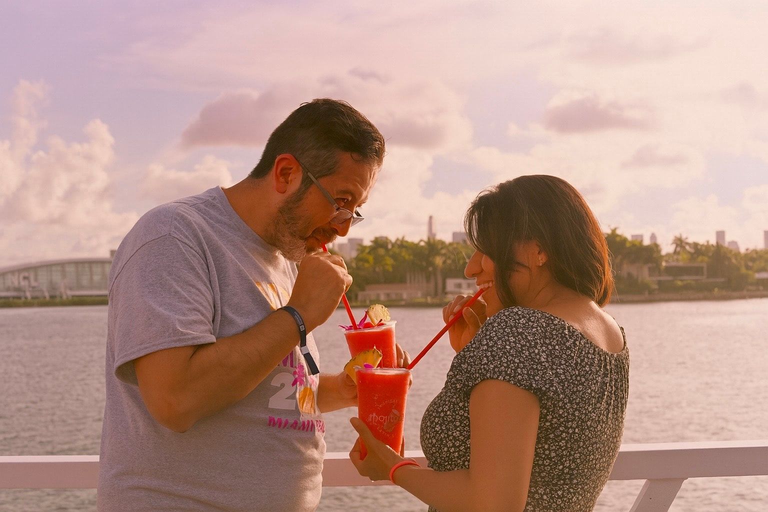 Couple Enjoying Fresh drinks on the Miami sightseeing Cruises from Bayside Marketplace to see the Homes of the Rich and Famous during the Miami Sunset