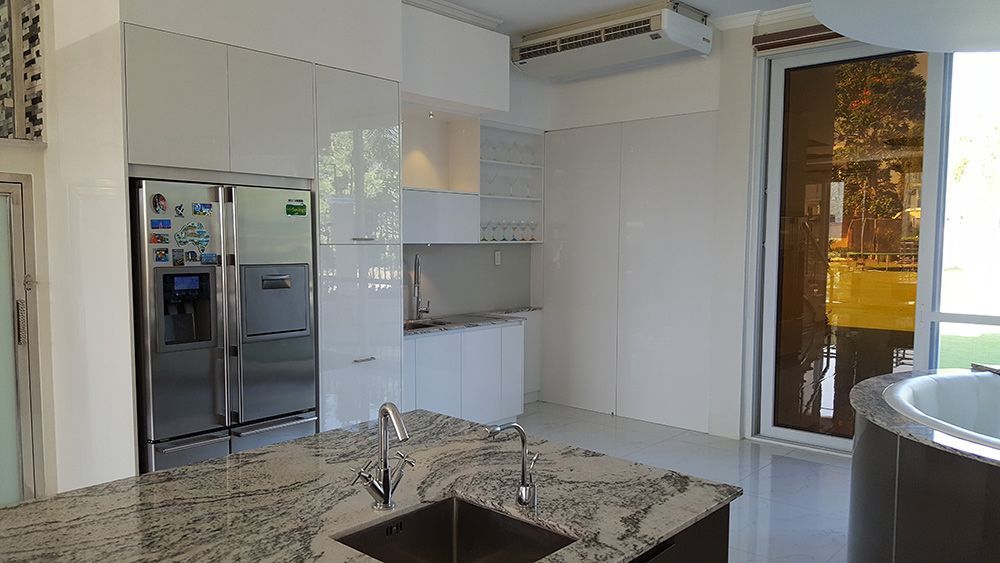 A Kitchen With A Sink, Refrigerator, And Sliding Glass Doors — ModulPlus in Hervey Bay, QLD