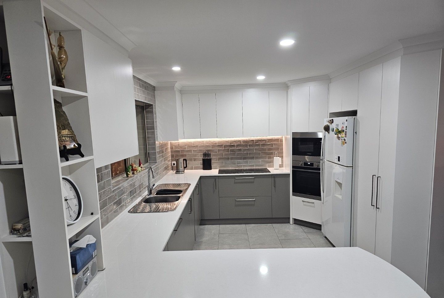 Modern Kitchen With Cabinets, Stainless Steel Appliances, and a Curved Countertop — ModulPlus in Maryborough, QLD