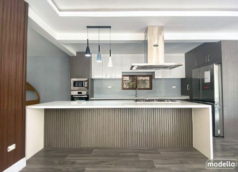 A Kitchen With a Large Island and Stainless Steel Appliances — ModulPlus in Hervey Bay, QLD