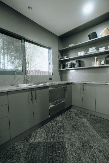 A Kitchen With Gray Cabinets and Stainless Steel Appliances — ModulPlus in Hervey Bay, QLD