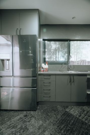 A Kitchen With Stainless Steel Appliances and a Stainless Steel Refrigerator — ModulPlus in Hervey Bay, QLD