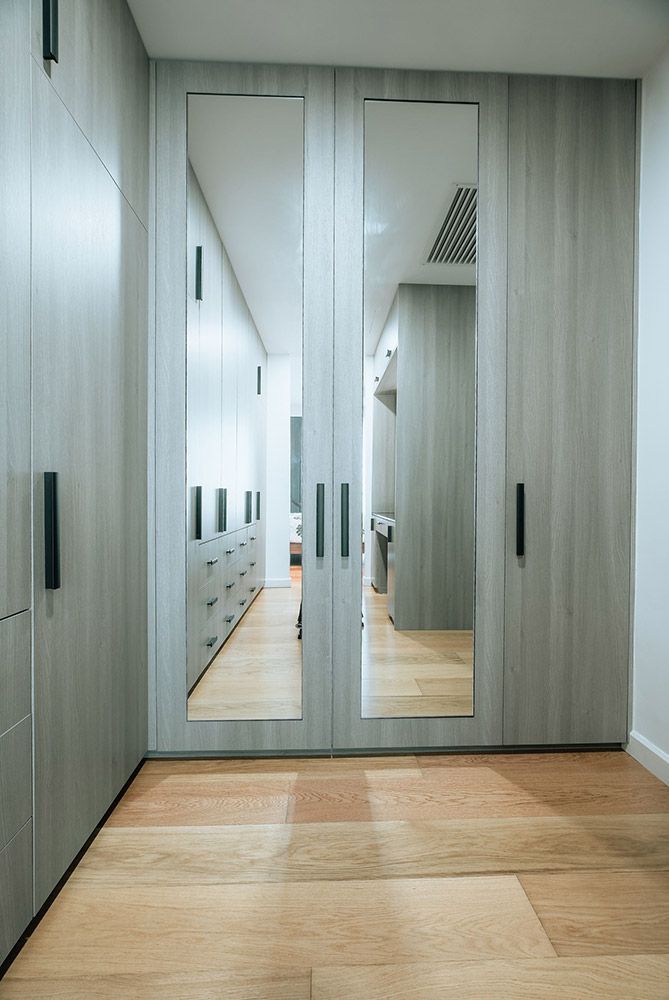 A Walk in Closet With a Large Mirror on the Door — ModulPlus in Hervey Bay, QLD