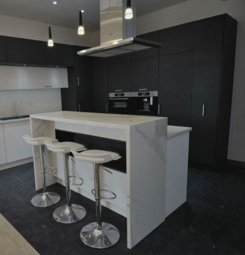 A Kitchen With a Large Island and Stools — ModulPlus in Hervey Bay, QLD