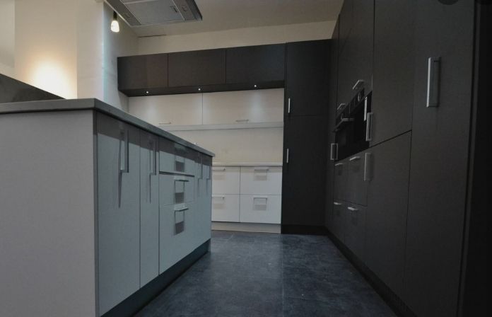A Kitchen With Black and White Cabinets and a Black Floor — ModulPlus in Hervey Bay, QLD