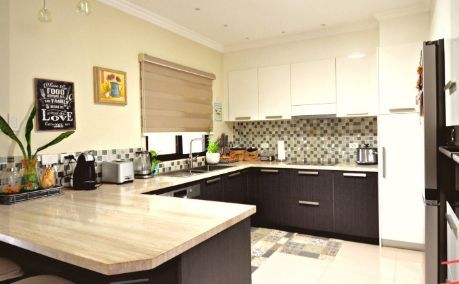 A Kitchen With Black Cabinets and a Wooden Counter Top — ModulPlus in Hervey Bay, QLD