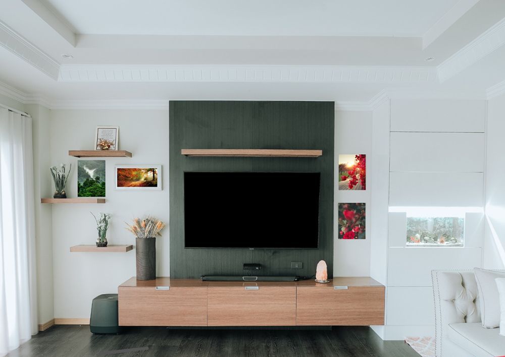 A Living Room With A Flat Screen Tv Mounted On The Wall — ModulPlus in Pialba, QLD