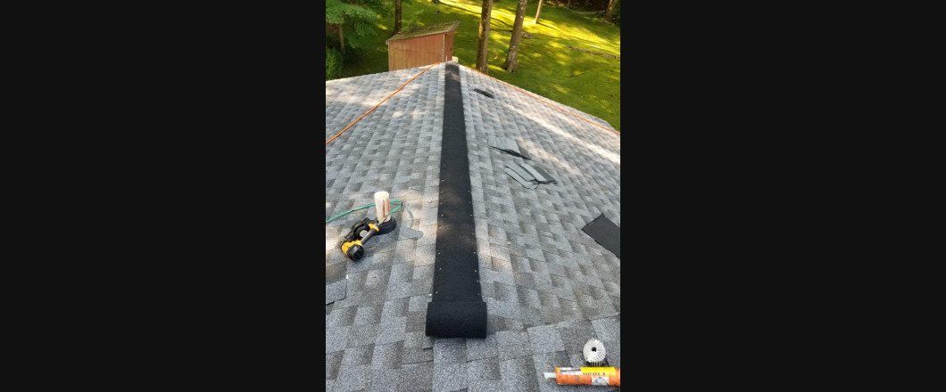 A piece of black tape is laying on top of a roof.