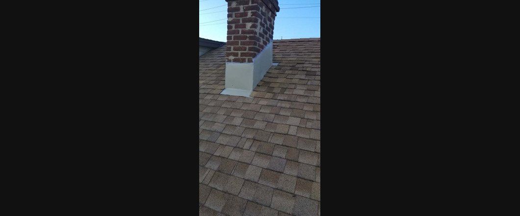 A chimney is sitting on top of a roof.