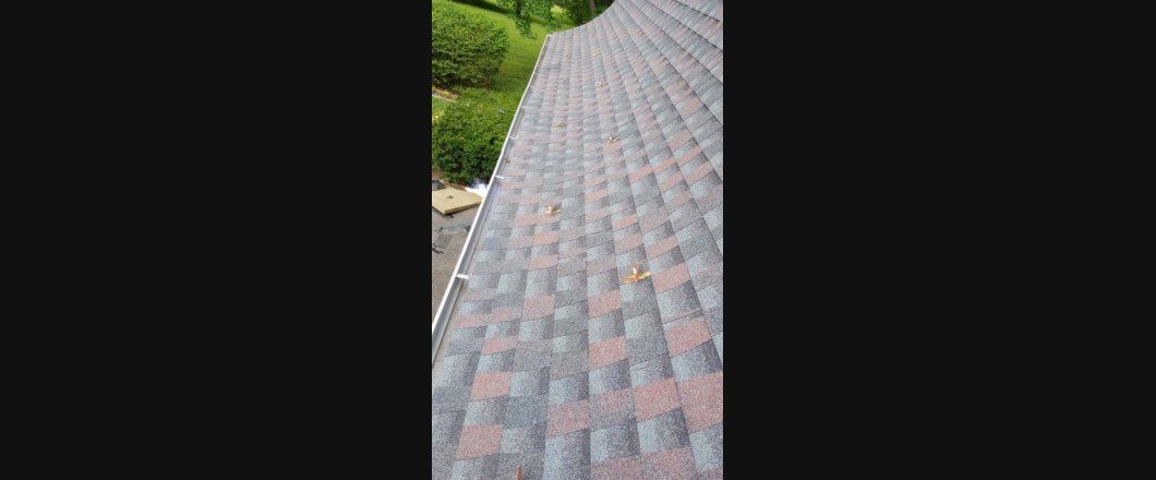 A close up of a roof with a gutter on it.