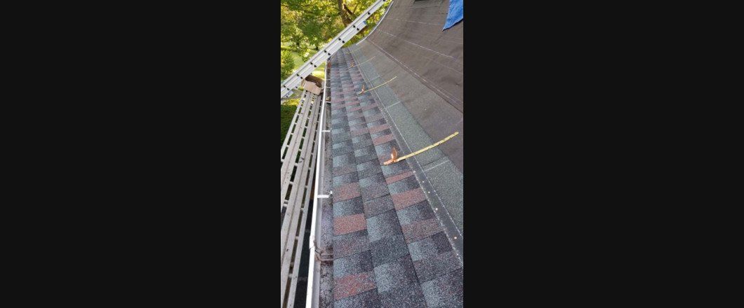 A person is standing on top of a roof.