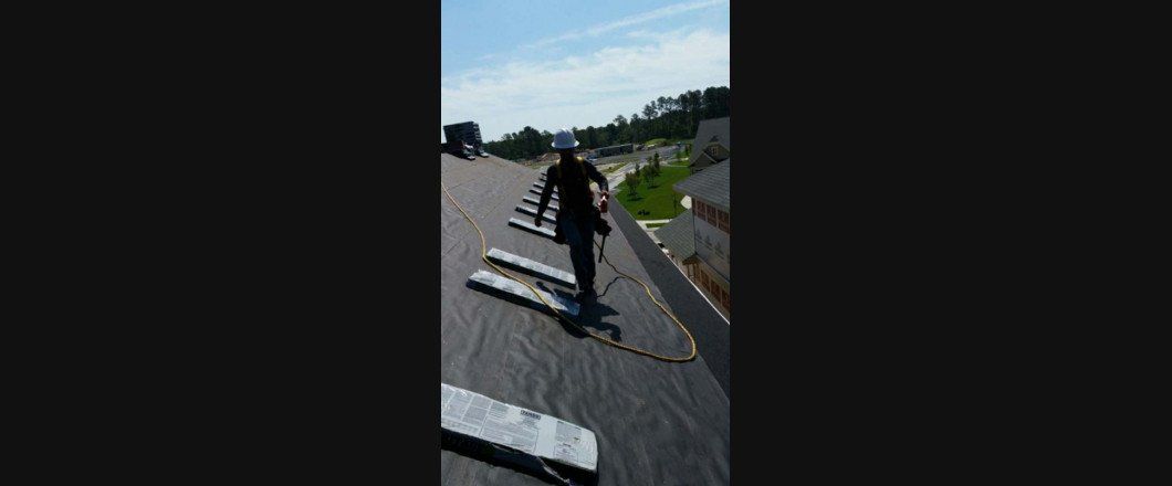 A person is walking on the roof of a building.