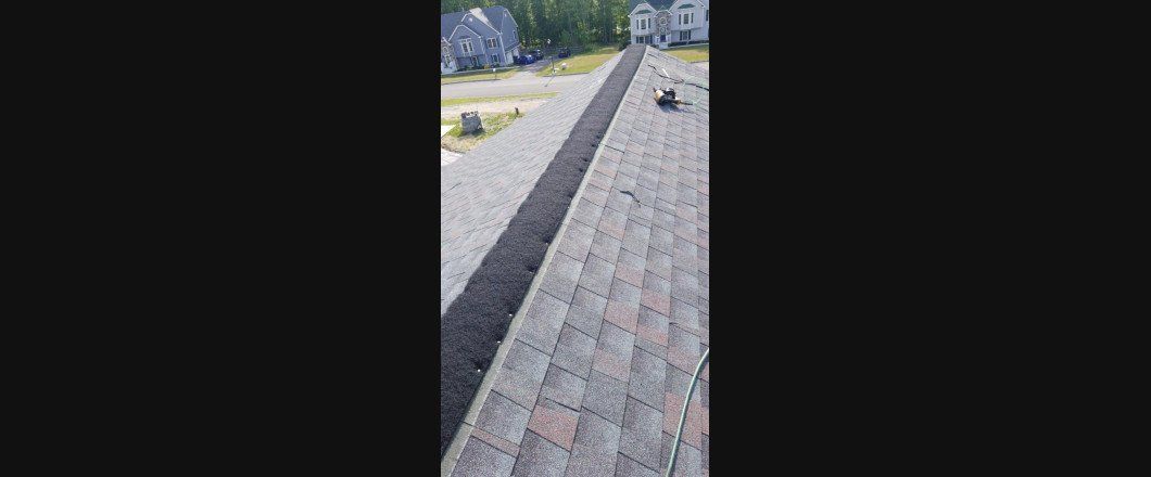 A person is walking down a brick sidewalk in a park.