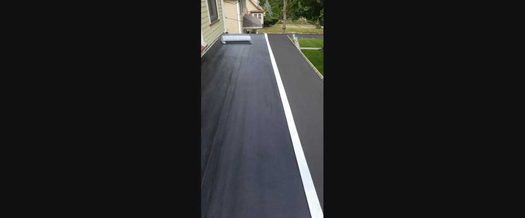 A black road with a white line on the side of it.