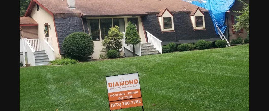A house with a for sale sign in front of it.