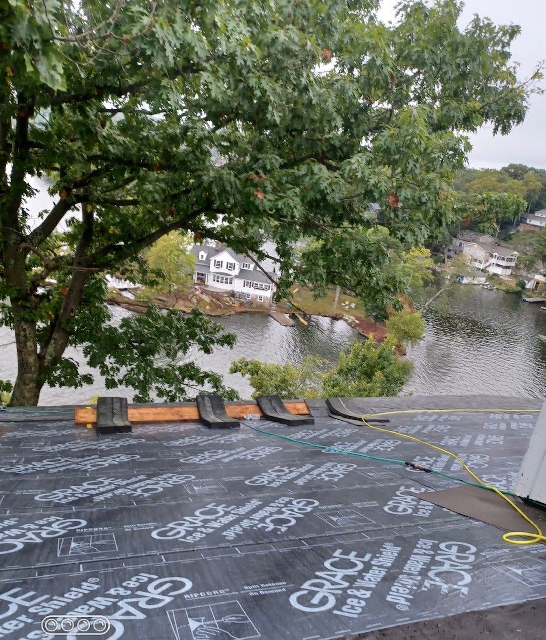 A roof with a view of a lake and trees