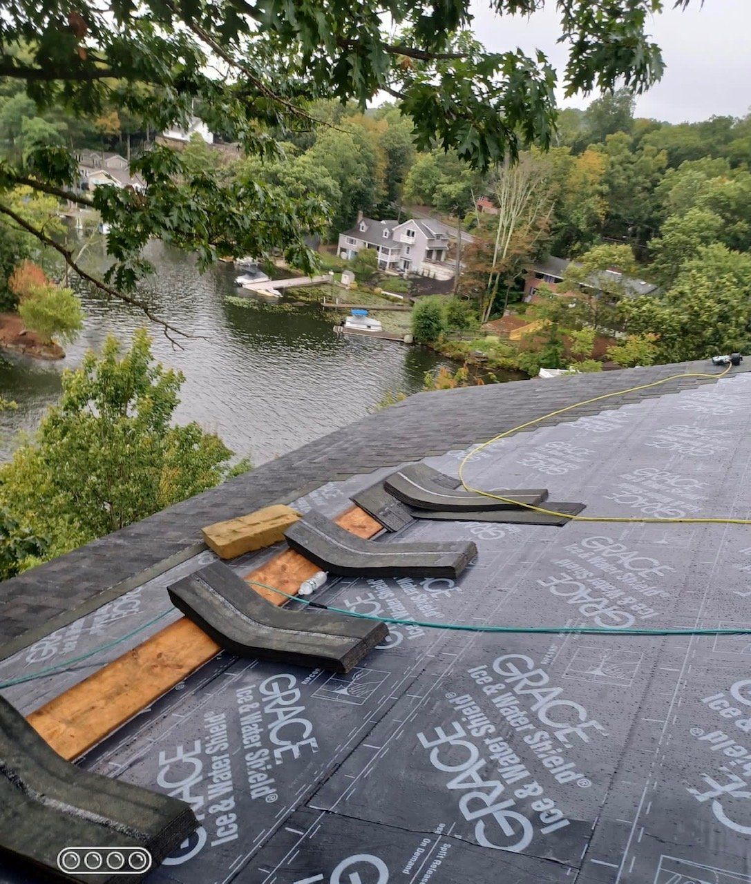 A roof with a view of a lake and trees