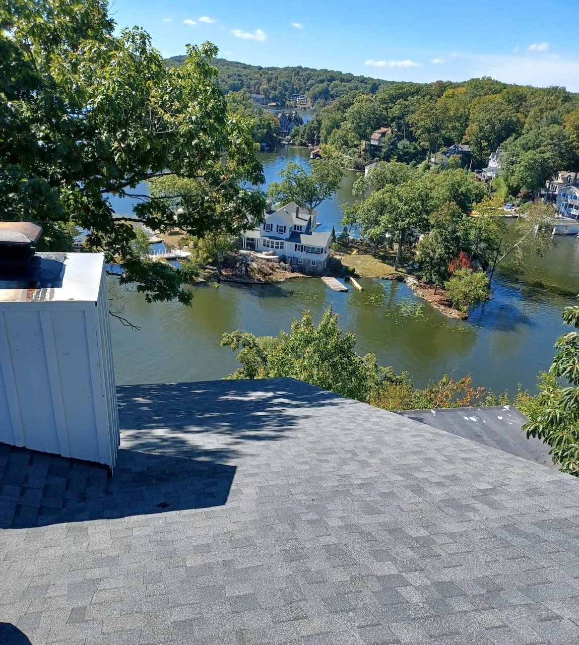 A view of a lake from the roof of a house