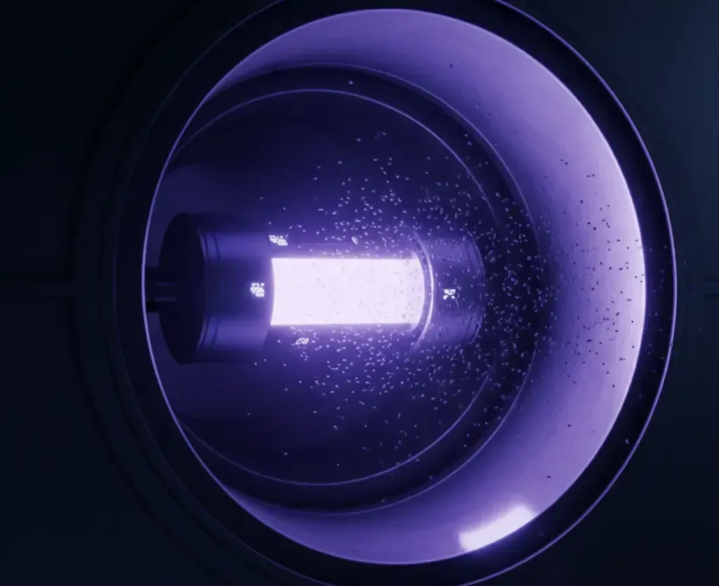 A powerful UV-C germicidal lamp glowing inside an HVAC duct, illustrating the technology used to kill biological contaminants.