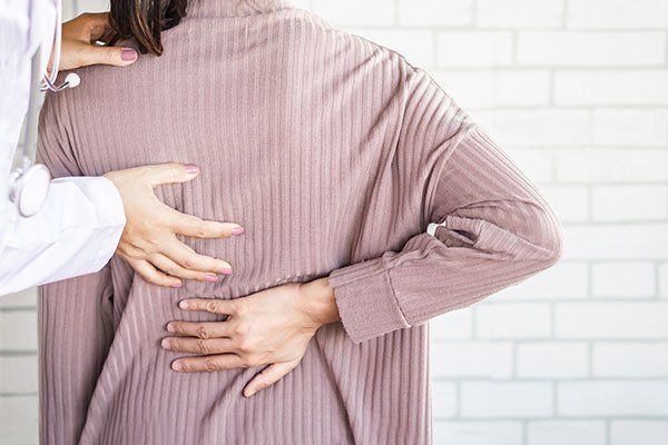 Doctor Examining a Patient — Springfield, MO — James River Chiropractic & Wellness Doctor Examining a Patient — Springfield, MO — James River Chiropractic & Wellness
